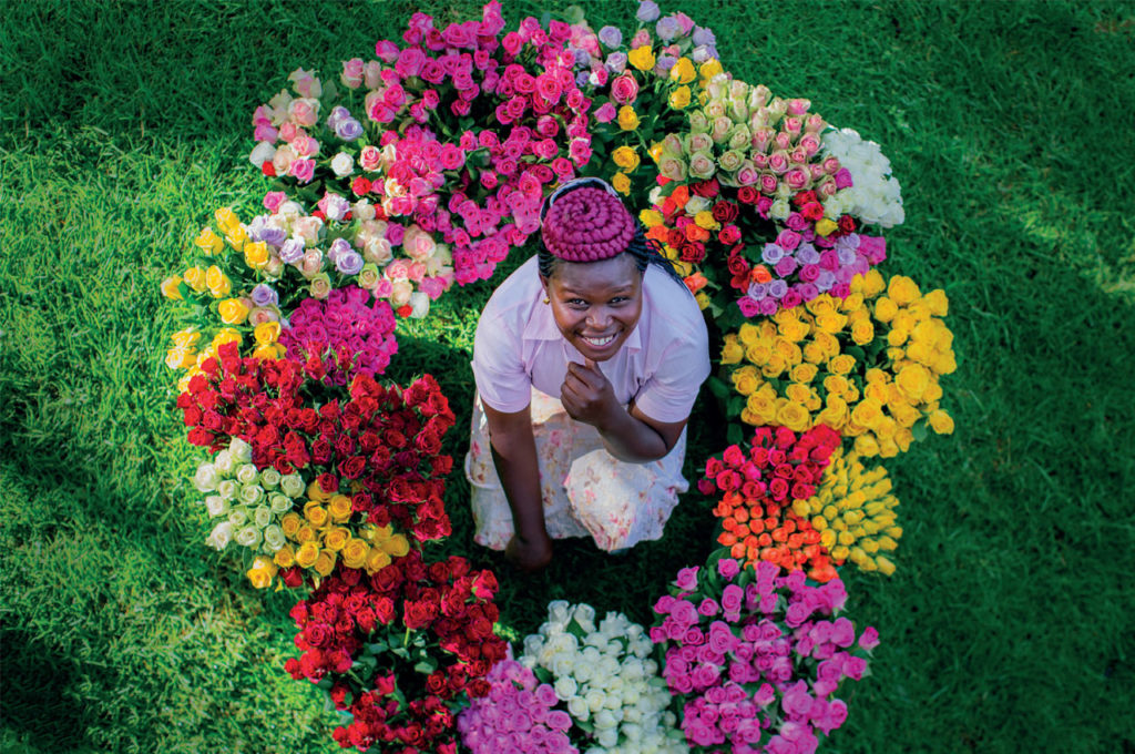 Portrait of Grace Otieno surrounded by colourful Fairtrade roses